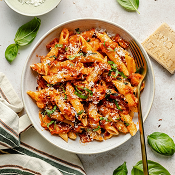 Penne pasta with tomato sauce and fresh basil