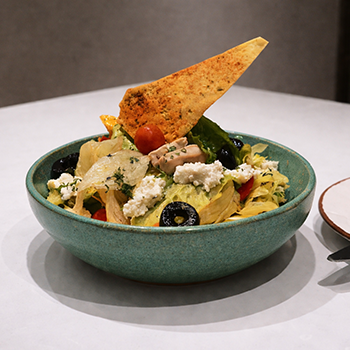 Fresh garden salad with greens, vegetables, and olives